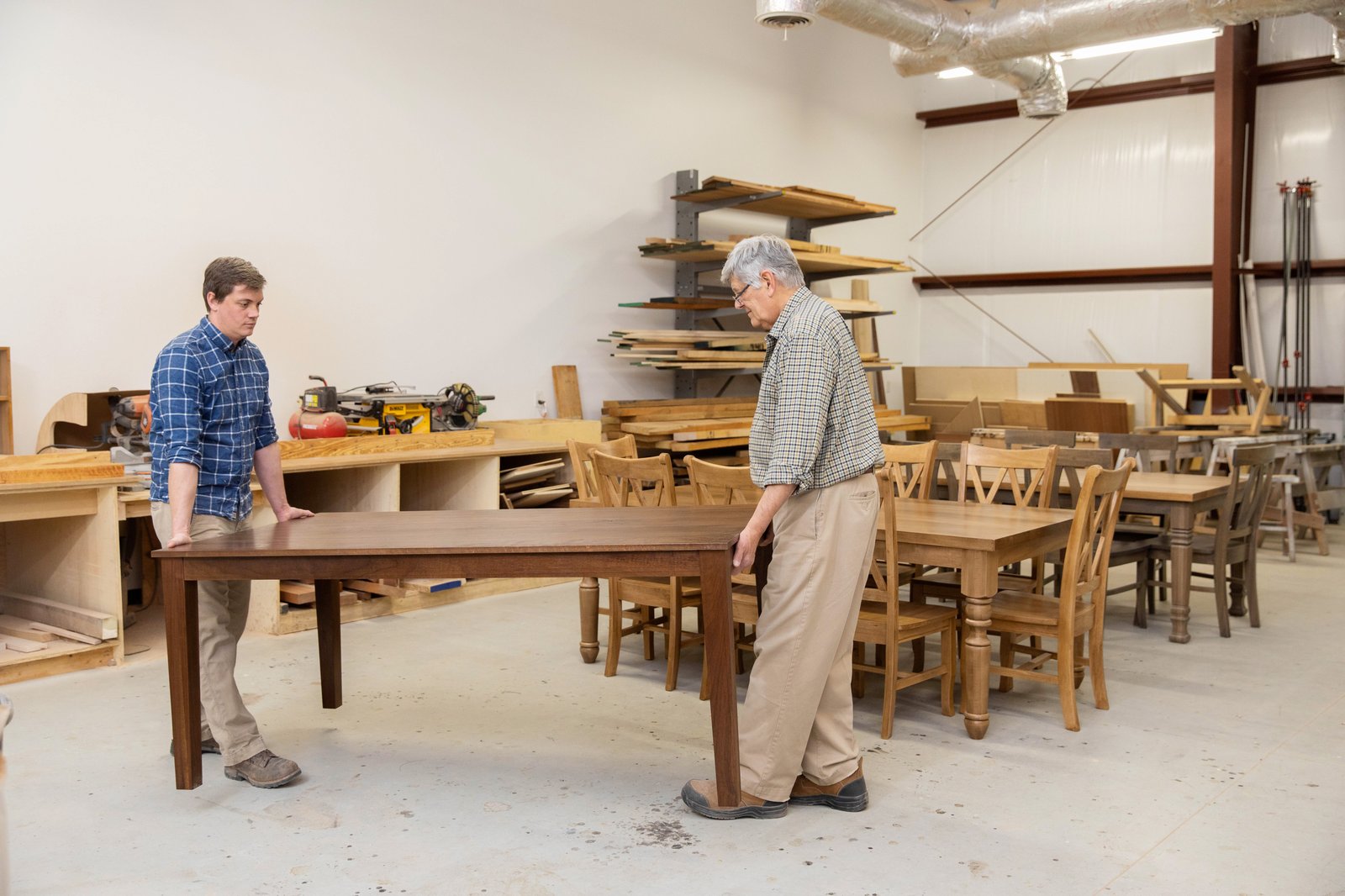 Work on a hardwood table in the Wilmington workshop